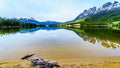 Reflection of the Rocky Mountains range on the smooth water surface of Yellowhead Lake in Robson Provincial Park Royalty Free Stock Photo