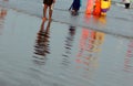 Reflection in sea tide of people in the beach