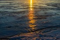 Reflection of the setting sun on the ice of a frozen lake Royalty Free Stock Photo