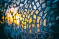 Reflection of the setting sun in the mirror pieces of glass mosaic - abstract background - shallow depth of field