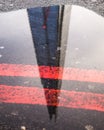 Reflection of the Shard in London in a puddle.