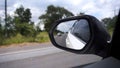 Reflection side rear view car mirror on road Royalty Free Stock Photo