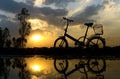 Reflection of Silhouette bicycle park on the waterfront Royalty Free Stock Photo