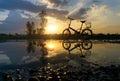 Reflection of Silhouette bicycle park on the waterfront Royalty Free Stock Photo
