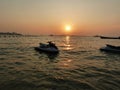 Reflection of Single Boat with Burning Sky During Sunrise/Sunset ,  Orange suface water flow flare Royalty Free Stock Photo