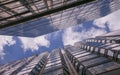 Reflection of clouds in glass walls of skyscrapers in the big city and the blue sky with white clouds