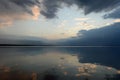 Reflection of the sky in the lake water in the calmness at sunset Royalty Free Stock Photo