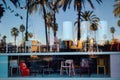 Reflection of the sky and palm trees in the window of a furniture store Royalty Free Stock Photo