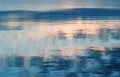 Reflection of the sky and the sun in sea water at dawn. Abstract pattern