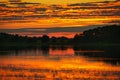 reflection of the sky in the water. gold, yellow and pink colors of the sky are reflected in the lake Royalty Free Stock Photo