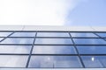 Reflection of the sky in the windows of a building. Perspective and underdite angle view to modern glass building Royalty Free Stock Photo