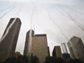 Reflection of skyscrapers in a mirrored installation with water tricles on a rainy day in Chicago