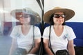 Reflection: smiling woman with straw hat