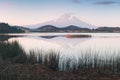 A reflection of snow capped Mount Shasta in a clear water in lake  at sunrise in California State, USA.  Mount Shasta is a volcano Royalty Free Stock Photo