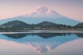 A reflection of snow capped Mount Shasta in a clear water in lake  at sunrise in California State, USA.  Mount Shasta is a volcano Royalty Free Stock Photo