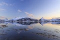 Reflection of snow-covered mountains in the fjord Royalty Free Stock Photo