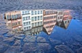 Reflection of some historic building of Frankfurt`s old city in a puddle of water