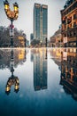 Reflection of some historic building of Frankfurt`s old city in a puddle of water, winter and snow