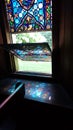 reflection and stained glass window of an 1866 gothic revival memorial church MOrris NY