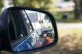 Reflection of a street cleaning worker in the rearview mirror of a car Royalty Free Stock Photo