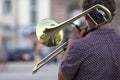 Reflection of the street in the instrument solo trumpet. male musician plays the trombone. music and creativity. jazz and Blues Royalty Free Stock Photo