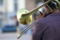 Reflection of the street in the instrument solo trumpet. male musician plays the trombone. music and creativity. jazz and Blues Royalty Free Stock Photo