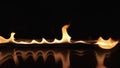 Reflection of a strip of fire in water.