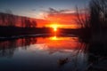 reflection of the sun rising over lake, with colors of dawn and sunrise Royalty Free Stock Photo