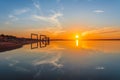 Reflection of the sun, sky, clouds and an abandoned house in river at the time of red sunset, a beautiful view of self-comfort, ca Royalty Free Stock Photo