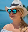 Reflection in sunglasses. Girl in a white straw hat Royalty Free Stock Photo