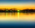 Reflection of sunset glow on the park pond Royalty Free Stock Photo