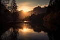 reflection of sunset on the lake and chapel in mountains, with silhouette of trees Royalty Free Stock Photo