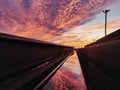 Reflection of the sunset in a piece of rail Royalty Free Stock Photo