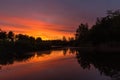 Reflection of a sunset in a pond with amazing colours in Waterschei near Genk in Belgium