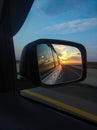 Reflection of the sunset in the rearview mirror of a car Royalty Free Stock Photo