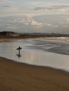 Reflection of a surfer standing at the Somo beach, in Cantabria, Spain Royalty Free Stock Photo