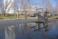 Reflection of tall building at puddle of water Royalty Free Stock Photo