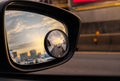 Reflection of traffic flow on asphalt road in side mirror of blue SUV. Car wing mirror with convex mirror for safety driving. View Royalty Free Stock Photo