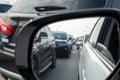 Reflection of traffic flow in left side rear view mirror at rush hour Royalty Free Stock Photo