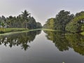 Reflection of trees appears on water.