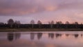 Reflection of trees in a calm surface of the river, in the early morning Royalty Free Stock Photo