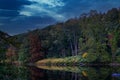 Reflection of trees in a lake during autumn season. Wilderness at sunset Royalty Free Stock Photo