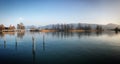 Reflection of trees in the mountain lake in Switzerland, March 2019 Royalty Free Stock Photo