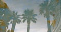 Reflection of tropical palm tree in waving water surface. holiday and travel