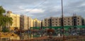 Reflection of under construction modern housing buildings over stagnant rain water at a construction site. Royalty Free Stock Photo