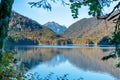 Reflection view in a lake with autumn forest and mountains in the Alps in the morning Royalty Free Stock Photo