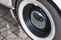 Reflection of a vintage car in the hubcap of a vintage car