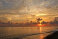 Reflection of vivid sunset sky over sea. Colorful sunrise with clouds over ocean. Beautiful nature background - orange sunset. Royalty Free Stock Photo