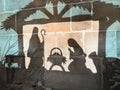 Reflection on the wall of christmas creche with Joseph Mary and small Jesus in a crib Royalty Free Stock Photo