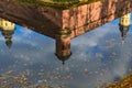 Reflection in the water of an old, ancient medieval castle in the center of Europe with towers and spiers. The background Royalty Free Stock Photo